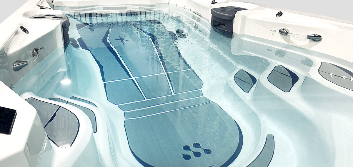 Nonslip comfort floor system on bottom of swim spa.