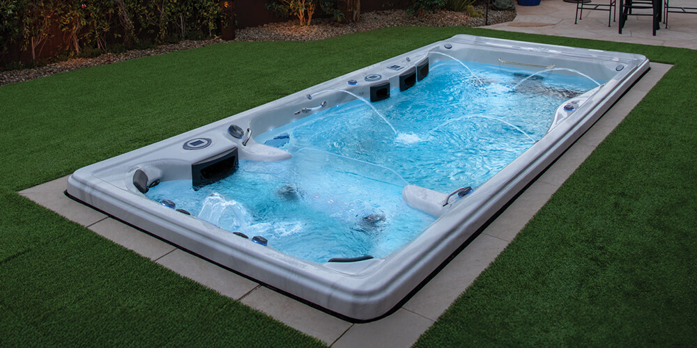 A swim spa set in the ground.